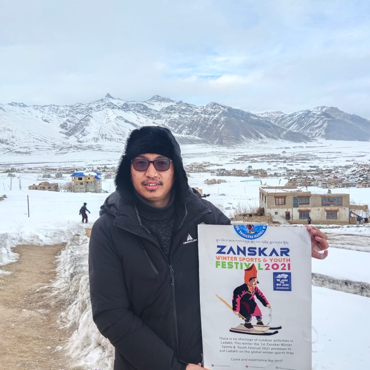 The MP of Ladakh, Mr. Jamyang Tsering Namgyal, holds up a poster and encourages us to read it. Image from the official Facebook page of the event