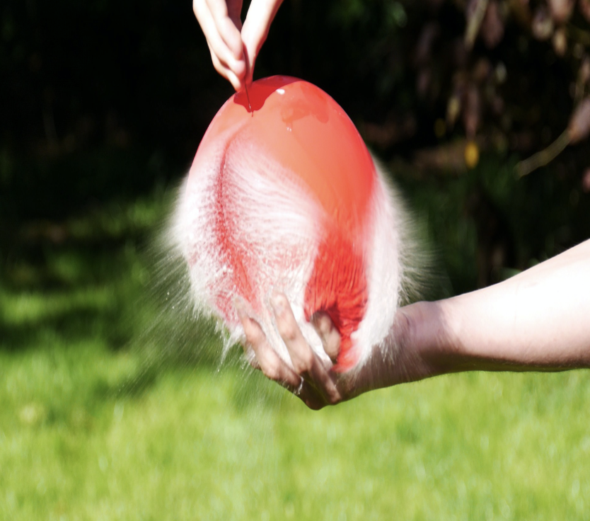 The surface molecules of the balloon being pulled apart due to relieve of tension.