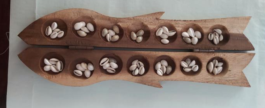 Indian game with wooden board and Cowrie shells