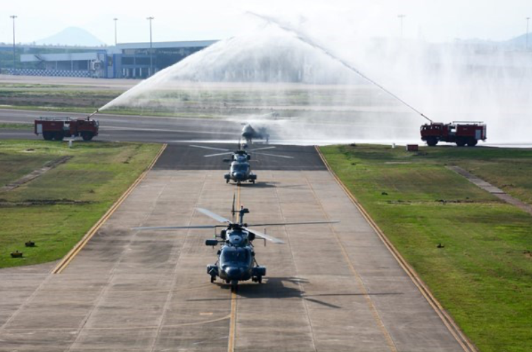 Image: The helicopters flying into INS Dega under the customary water salute. Image shared by Spokesperson Navy.