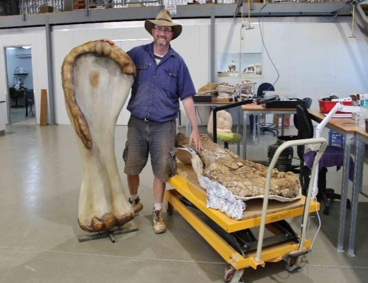 Scott Hocknull with fossil humerus (right) & 3-D printed reconstruction (left)